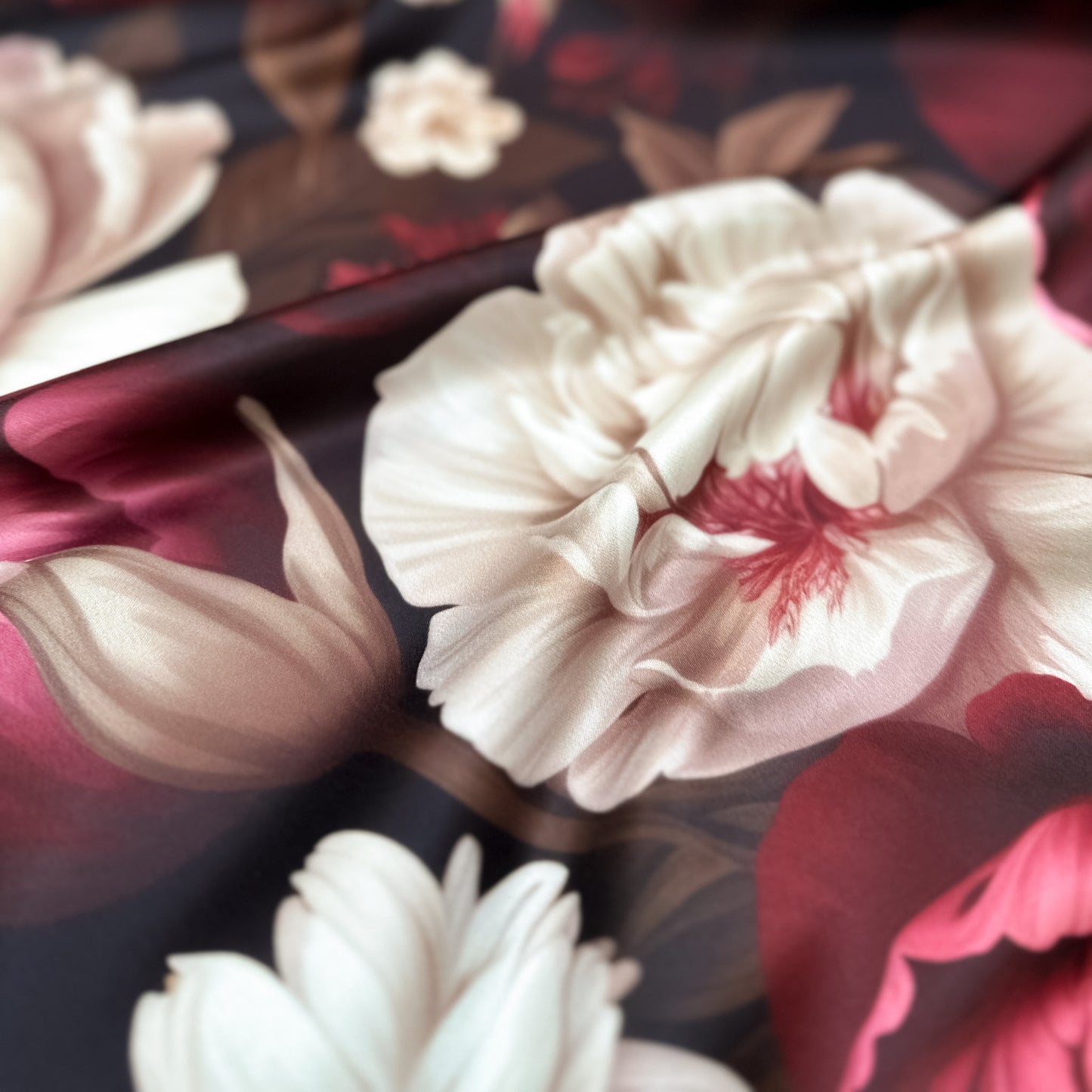 Floral Fantasy – floral print on luxurious duchesse satin with burgundy and cream blossoms on dark background, glossy surface and sculptural folds, design by Sewing Club.